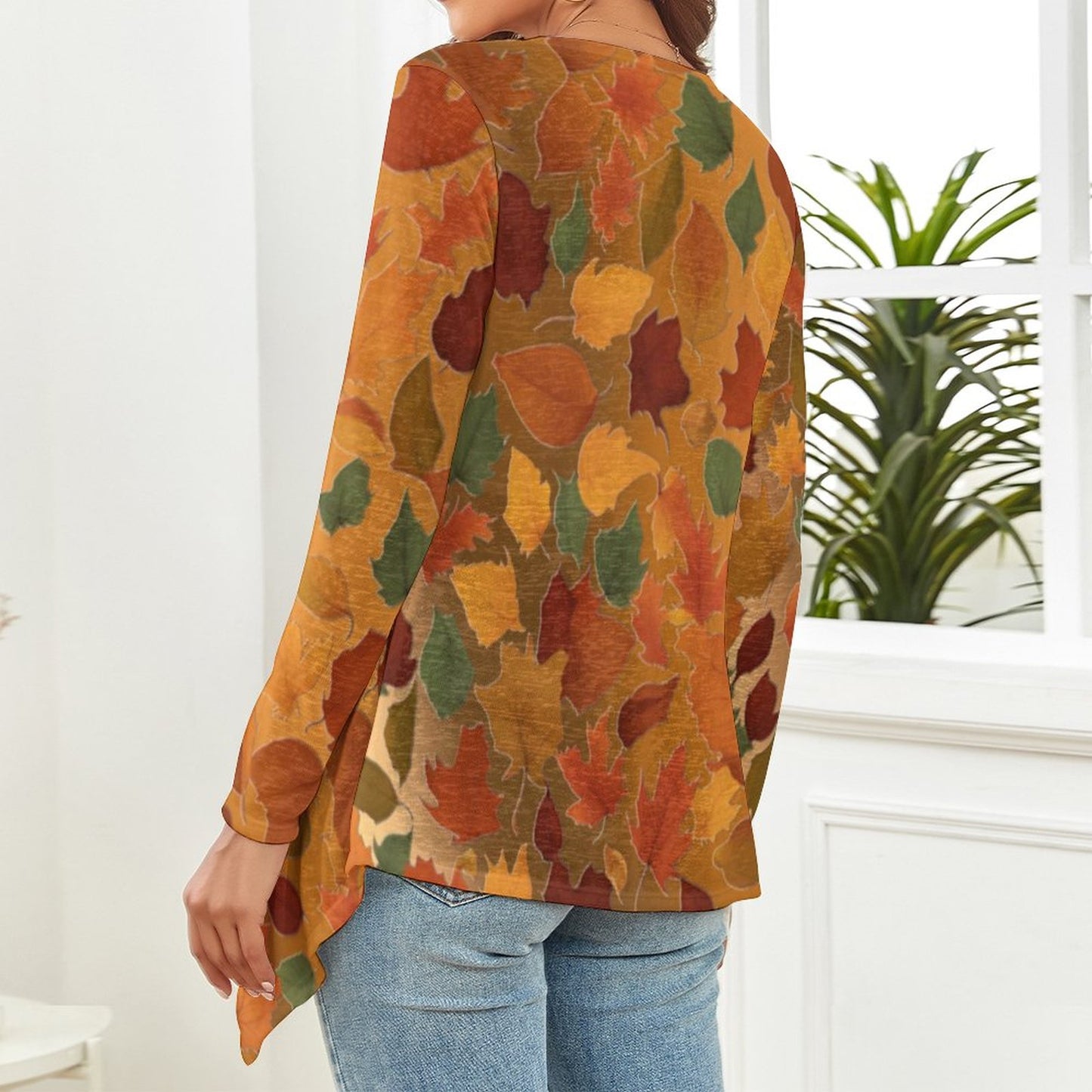 The backside of a woman wearing a colorful leaf-patterned shirt in a room with a plant. - Printspirationz