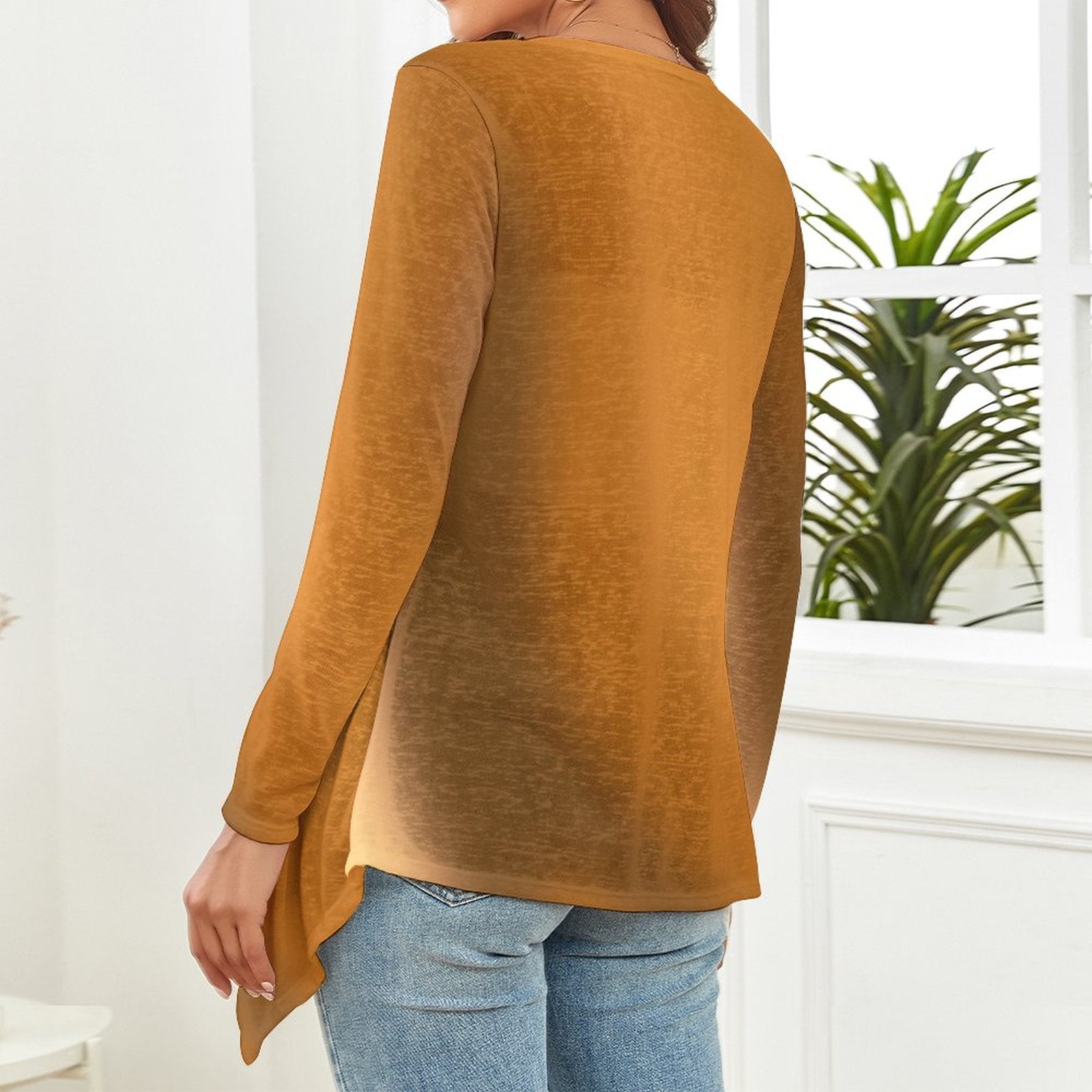 The backside of a woman wearing a gradient brown long-sleeve top and blue jeans in a room with a plant in the background. - Printspirationz