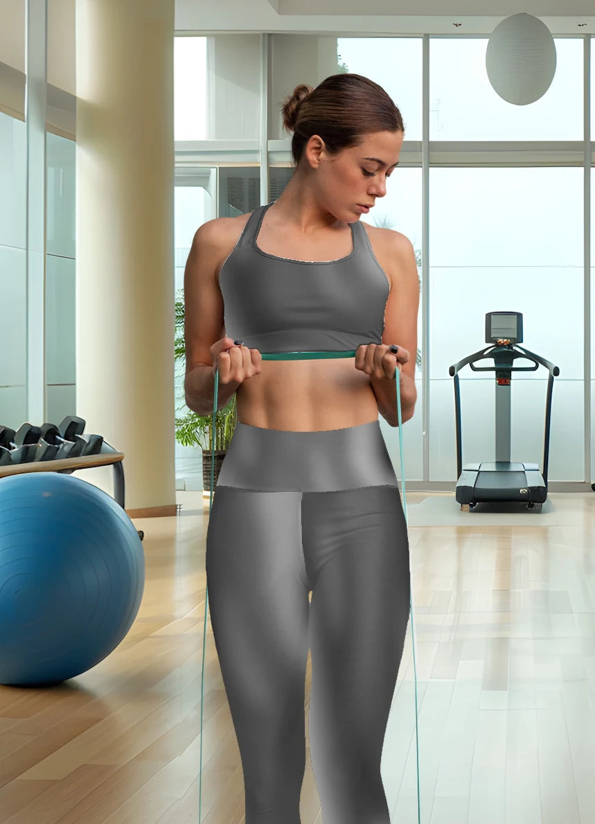 Woman wearing black gradient High Waist Yoga Leggings exercising with resistance bands in a gym setting - Printspirationz