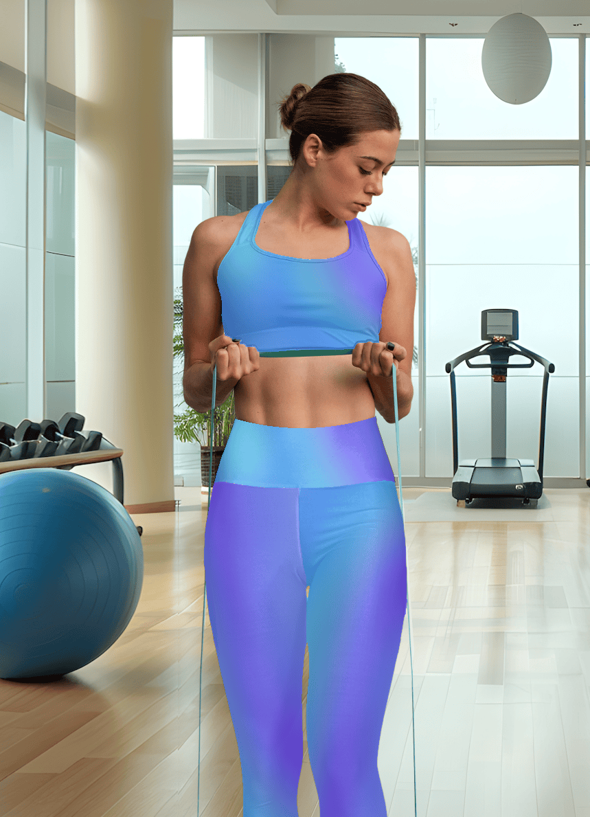 Woman in Vibrant Gradient Blue High Waist Yoga Leggings, exercising with resistance bands in a gym setting - Printspirationz