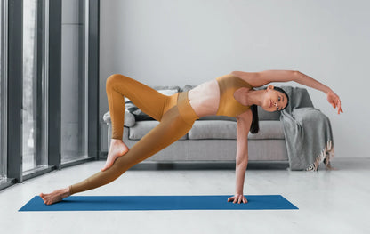 Woman practicing yoga indoors wearing brown colored High Waist Yoga Leggings activewear leggings on blue mat - Printspirationz