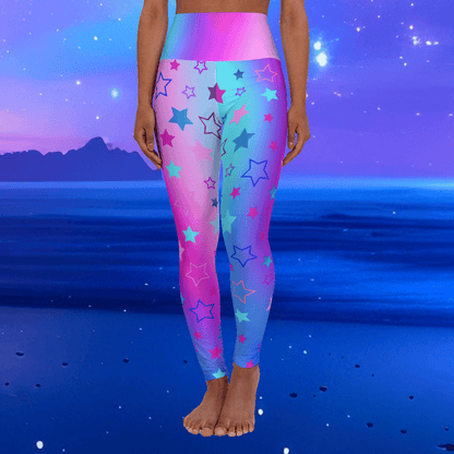 Woman wearing high waist yoga leggings with colorful cool tones star patterns on a blue and pink gradient background - Printspirationz