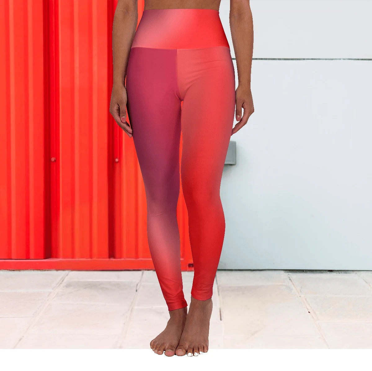 Person wearing Vibrant Gradient Red High Waist Yoga Leggings standing against a colorful wall. - Printspirationz