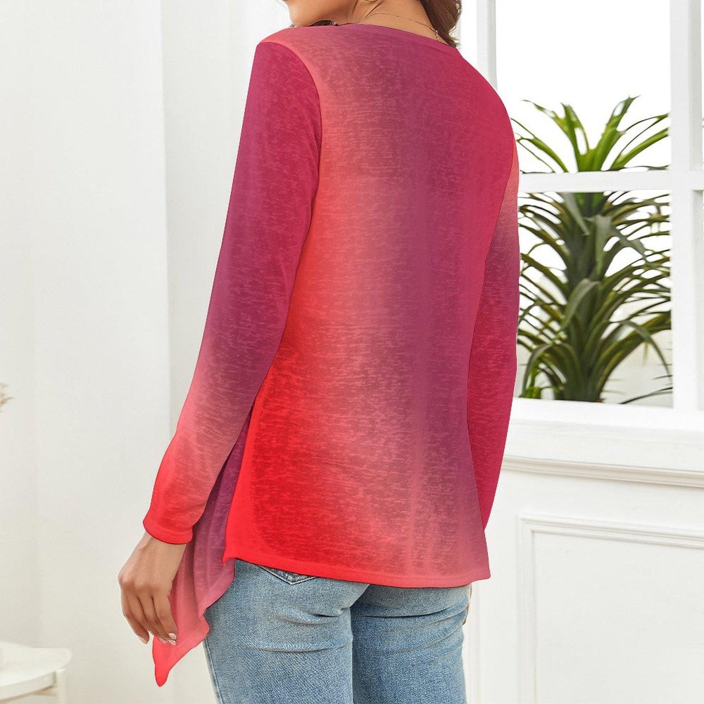The backside of a woman wearing a gradient red long-sleeve top and blue jeans in a room with a plant in the background. - Printspirationz