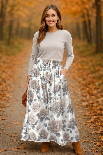 Woman in a floral skirt and light beige top and long Sepia Rose floral skirt standing in an autumn forest- Printspirationz